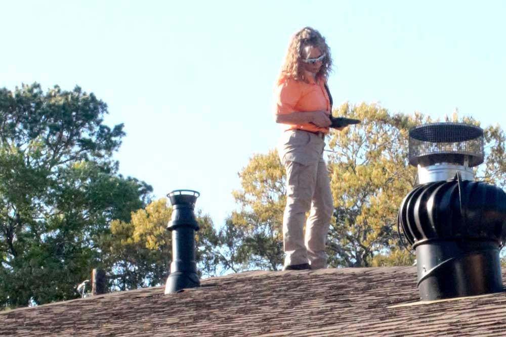Michelle on the roof preforming home inspection services 