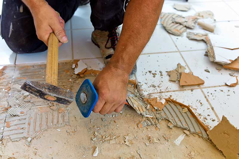 Floor tiles being broken during a home renovation. 